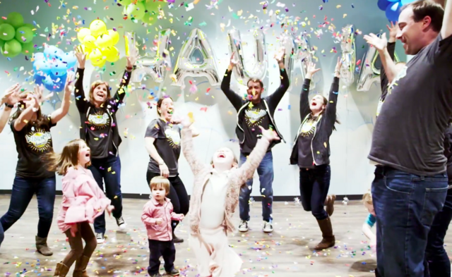 volunteers and preschoolers in confetti sprinkling down