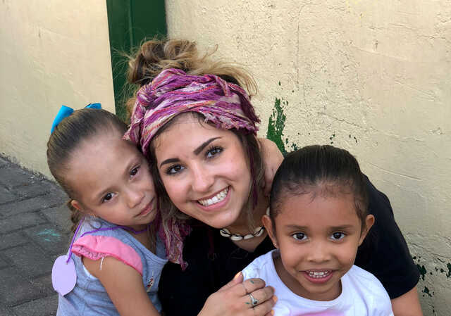 woman on a mission trip with children