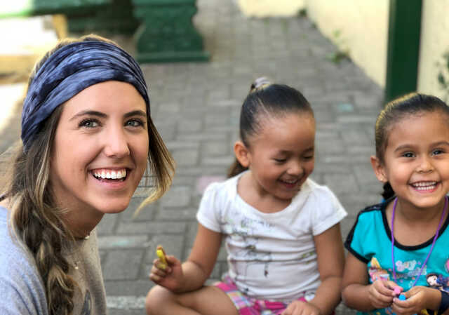 woman on a mission trip with children