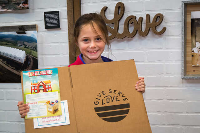Little girl with Give Serve Love box