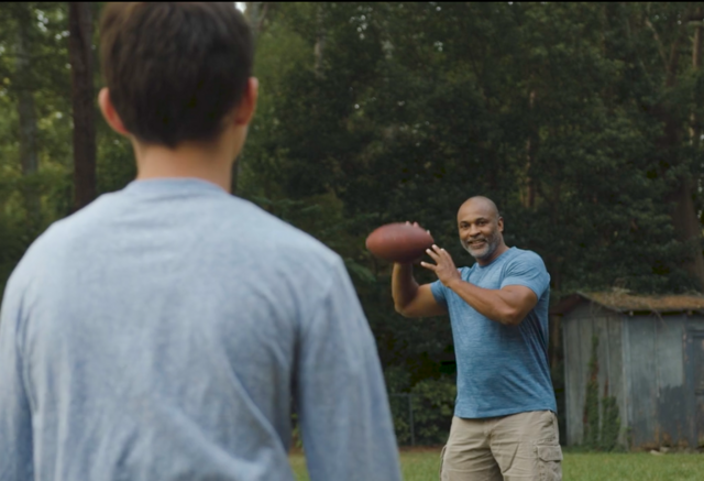 Father and son throwing a football