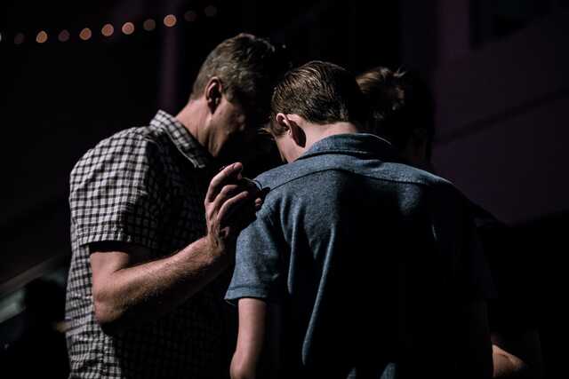 men standing together praying